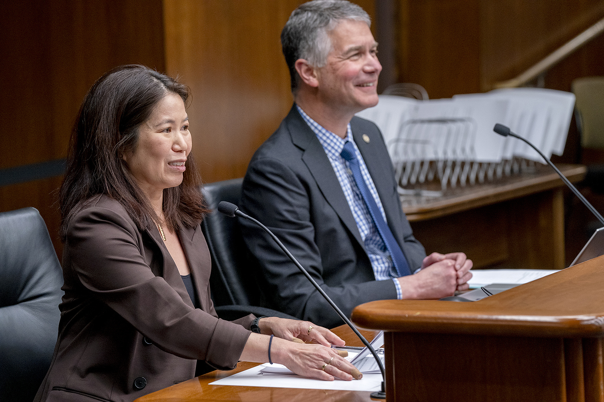 Stacey Fujii, government affairs director for Great River Energy, testifies before the House's climate and energy committee Feb. 28 on HF3704, sponsored by Rep. Larry Kraft, right. (Photo by Michele Jokinen)